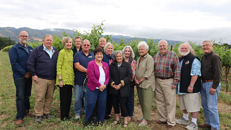 Outdoor photo of board of directors at vinyard